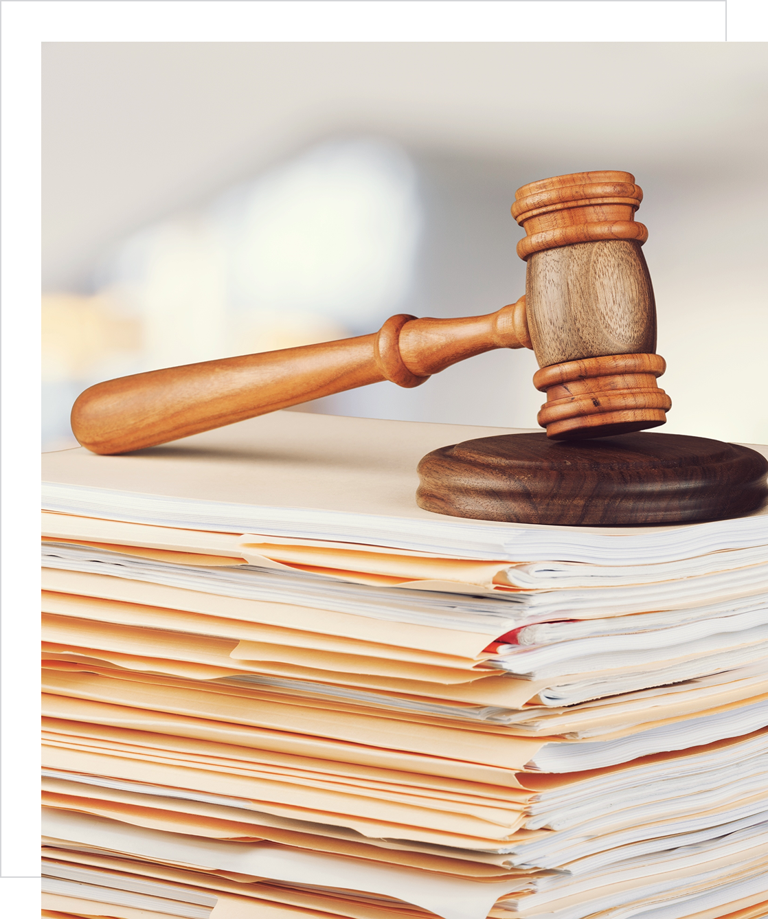 A judge's gavel resting on a stack of legal documents.