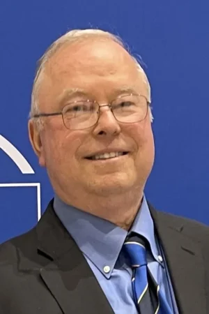 Portrait of a middle-aged man in glasses and suit.