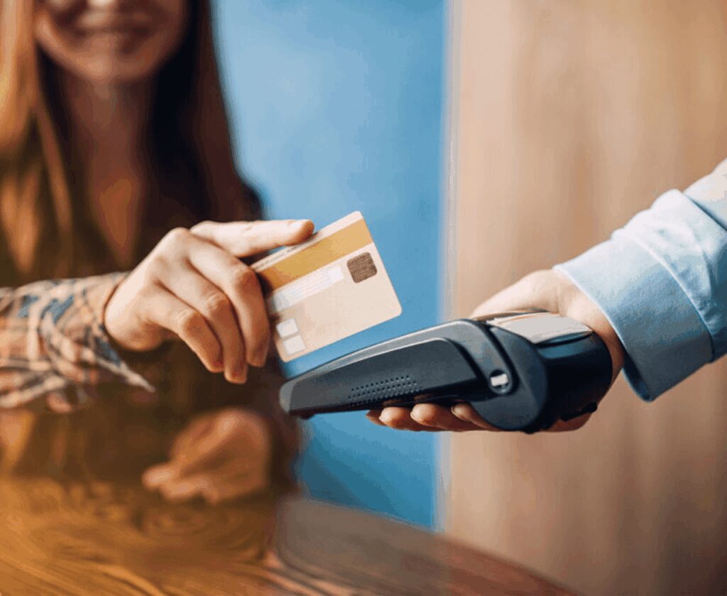 Woman using contactless payment with card.